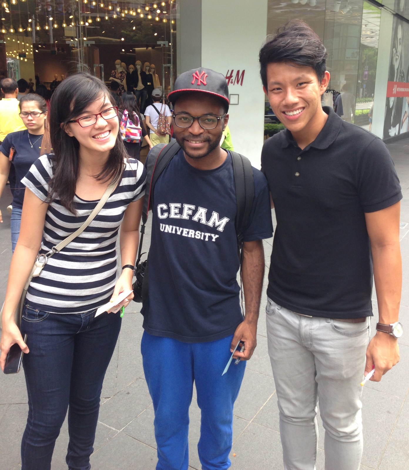 Kenneth (on the far right), his classmate (on the far left), and a stranger!